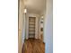 Hallway with built-in shelving and hardwood floors at 1883 S Pierce St, Lakewood, CO 80232