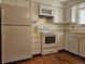 Kitchen features white cabinets, microwave, and range at 1883 S Pierce St, Lakewood, CO 80232