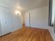 Spacious bedroom with hardwood floors and an adjacent bathroom at 1883 S Pierce St, Lakewood, CO 80232