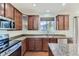 Modern kitchen featuring granite countertops, stainless steel appliances, and ample cabinetry at 10217 Greenfield Cir, Parker, CO 80134