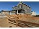 Two-story house with gray siding, stone accents, and a wooden fence at 3886 N Irvington St, Aurora, CO 80019