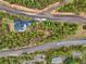 Aerial view of house and property, showing surrounding trees and roads at 6763 Deer Path, Evergreen, CO 80439