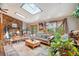 Spacious living room features a stone fireplace, large windows, and skylights at 6763 Deer Path, Evergreen, CO 80439