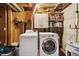Basement laundry room with washer, dryer, and storage at 6763 Deer Path, Evergreen, CO 80439