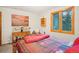 Bright bedroom featuring a double bed and large window at 6763 Deer Path, Evergreen, CO 80439