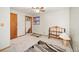 Simple bedroom with ceiling fan and large window at 6763 Deer Path, Evergreen, CO 80439