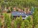 House with large deck, mountain view, and road at 6763 Deer Path, Evergreen, CO 80439