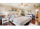 Main bedroom with hardwood floors and access to bathroom at 6763 Deer Path, Evergreen, CO 80439