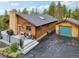 View of the log home from the side, showing its size and features at 6763 Deer Path, Evergreen, CO 80439