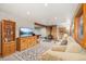 Finished basement with wood stove, TV, and access to game room at 6763 Deer Path, Evergreen, CO 80439