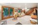 Bright basement rec room with large windows and access to deck at 6763 Deer Path, Evergreen, CO 80439