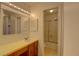 Clean bathroom with a yellow vanity and a shower/tub combo at 1050 S Monaco Pkwy # 88, Denver, CO 80224