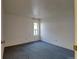 Simple bedroom with neutral walls and carpeting at 1050 S Monaco Pkwy # 88, Denver, CO 80224