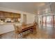 Open concept dining room with kitchen access and parquet flooring at 1050 S Monaco Pkwy # 88, Denver, CO 80224