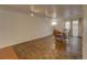 Bright dining room features parquet flooring and a wooden table with chairs at 1050 S Monaco Pkwy # 88, Denver, CO 80224