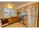 Efficient kitchen with wood cabinets, stainless steel appliances, and ample counter space at 1050 S Monaco Pkwy # 88, Denver, CO 80224