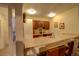 Small kitchenette with wood cabinets and a breakfast bar at 1050 S Monaco Pkwy # 88, Denver, CO 80224