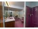 Bathroom with pink tile, a bathtub, and shower at 2862 N Monroe St, Denver, CO 80205