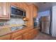 Oak kitchen with stainless steel appliances and tile backsplash at 2862 N Monroe St, Denver, CO 80205