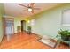 Living room with hardwood floors, ceiling fan and laundry area at 2862 N Monroe St, Denver, CO 80205