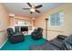 Gathering room with ceiling fan,reclining chairs and teal carpet at 2862 N Monroe St, Denver, CO 80205