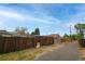 Backyard view of a house with wooden fence and alley access at 2862 N Monroe St, Denver, CO 80205