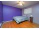 Bedroom with purple walls, hardwood floors, and ceiling fan at 2862 N Monroe St, Denver, CO 80205