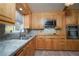 Kitchen with oak cabinets, granite countertops and stainless steel appliances at 2862 N Monroe St, Denver, CO 80205