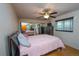 Spacious bedroom featuring mirrored closet doors and a ceiling fan at 2862 N Monroe St, Denver, CO 80205