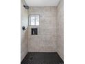 Modern shower with black hexagon tile floor at 1195 S Tejon St, Denver, CO 80223