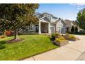 Two-story home with landscaped yard and large driveway at 10364 Carriage Club Dr, Lone Tree, CO 80124