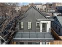 Modern two-story home with dark siding, a deck, and a white accent wall at 1828 S Williams St, Denver, CO 80210