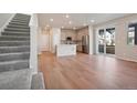 Open concept kitchen with modern appliances and light wood flooring at 21124 E 63Rd Dr, Aurora, CO 80019
