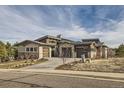 Contemporary home with a two-car garage and beautiful landscaping at 11364 Birolli Pl, Littleton, CO 80125