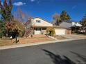 House front view, two-car garage and landscaping at 7507 Braun St, Arvada, CO 80005