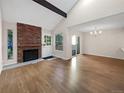 Spacious living room with hardwood floors and a brick fireplace at 2911 W Long Dr # D, Littleton, CO 80120