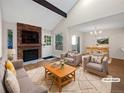 Virtually staged living room featuring a fireplace and dining area at 2911 W Long Dr # D, Littleton, CO 80120