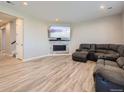 Spacious basement with fireplace and large sectional sofa at 27431 E 10Th Dr, Aurora, CO 80018