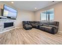 Finished basement with fireplace and large sectional sofa at 27431 E 10Th Dr, Aurora, CO 80018