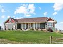 House exterior showcasing a spacious lawn and a country setting at 54333 E County Road 26, Strasburg, CO 80136