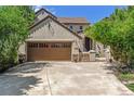 Two-story house with brown roof, stone accents, and a large driveway at 5021 Ballarat Ln, Castle Rock, CO 80108