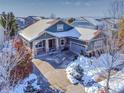 Stunning aerial view of a two-story home with a snow-covered yard at 7323 S Kellerman Way, Aurora, CO 80016