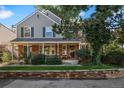 Two-story house with gray siding, green shutters, and porch at 6850 E Appleton Cir, Centennial, CO 80112