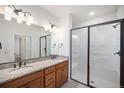 Double vanity bathroom with granite countertops and a large shower at 6153 N Ceylon St # 303, Denver, CO 80249
