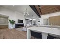 Open-concept living room with fireplace and kitchen island at 5061 Moss Pl, Golden, CO 80403