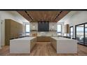Gourmet kitchen with double islands, modern appliances, and wood flooring at 5061 Moss Pl, Golden, CO 80403