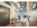 Stylish entryway with exposed ductwork, hardwood floors and unique decor at 2020 Arapahoe St # 950, Denver, CO 80205