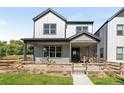 Two-story craftsman home with gray siding and a fenced yard at 3580 W 62Nd Pl, Denver, CO 80221