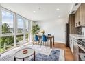 Dining area with river views and stylish blue chairs at 3575 Chestnut Pl # 705, Denver, CO 80216