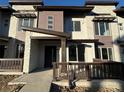 Modern townhome exterior with stone and wood accents, and a small front patio at 14584 W 91St Dr # D, Arvada, CO 80005